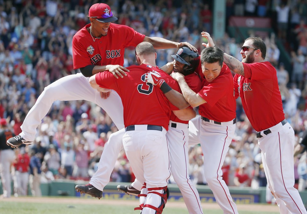 Boston Red Sox infielder Jonathan Herrera, center, celebrates his game-winning RBI single with teammates Xander Bogaerts, left, David Ross, Koji Uehara and Mike Napoli in the ninth inning Saturday against the Baltimore Orioles in Boston. The Red Sox won 3-2 in the first game of a doubleheader.