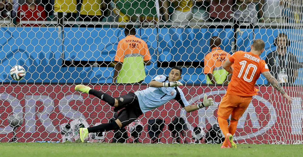 Netherlands’ Wesley Sneijder scores in a penalty shoot out during the World Cup quarterfinals at the Arena Fonte Nova in Salvador, Brazil. The Netherlands won 4-3 on penalty kicks after the match ended 0-0 after extra time.