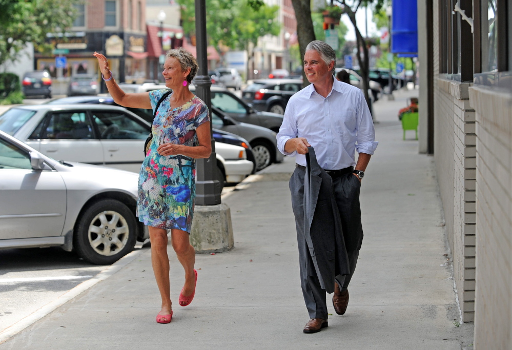 Karen Heck, mayor of Waterville, walks on Main Street in downtown with new Colby College President David Greene after lunch at Barrel’s Community Market on Tuesday, July 1, 2014.