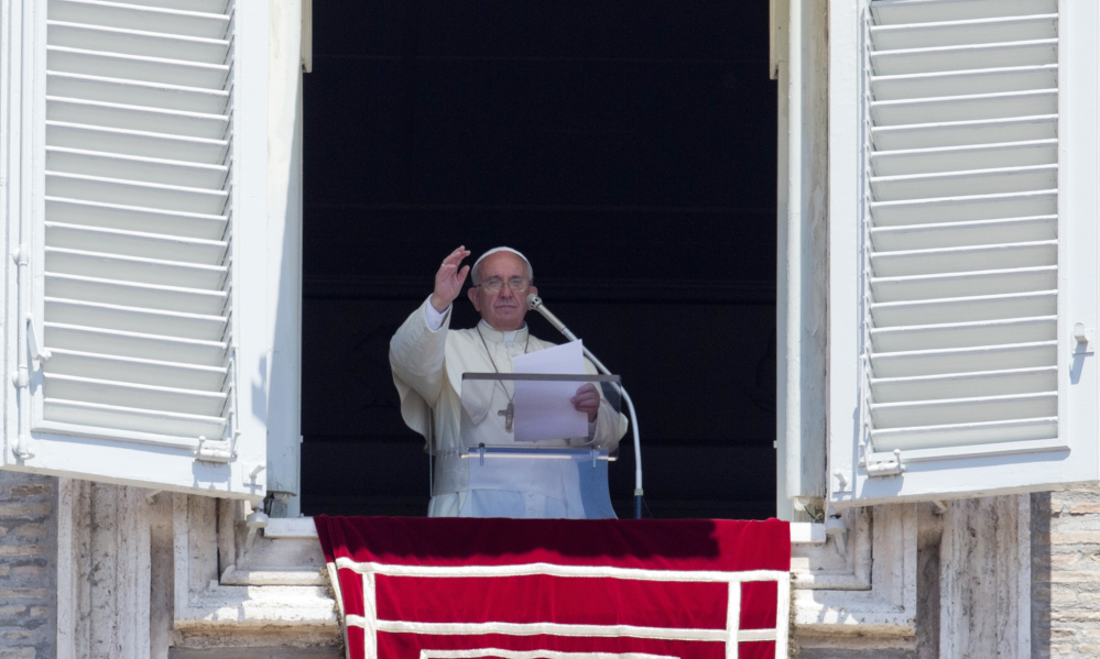 Pope Francis celebrates the Angelus noon prayer from his studio window overlooking St. Peter’s square, at the Vatican, Sunday.