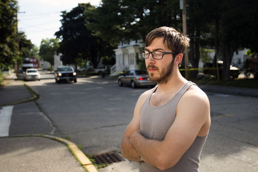 BIDDEFORD, ME - JULY 7: Goliath Vanalehen, who lives in one of the apartments at 19 Western Avenue in Biddeford, reacts Monday, July 7, 2014, the morning after two men were shot in the building and later died, one at Maine Medical Center in Portland and the other in the ambulance. Danalehen said his pets are still in the apartment but police still had the scene roped off as of 10 am Monday. (Photo by Gabe Souza/Staff Photographer)