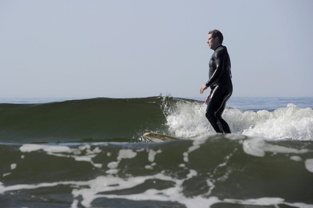 KENNEBUNK, ME - JUNE 28: Justice John O'Neil, who sits in York County Superior Court, surfs at Kennebunk Beach on Saturday, June 28, 2014. (Photo by Logan Werlinger/Staff Photographer)