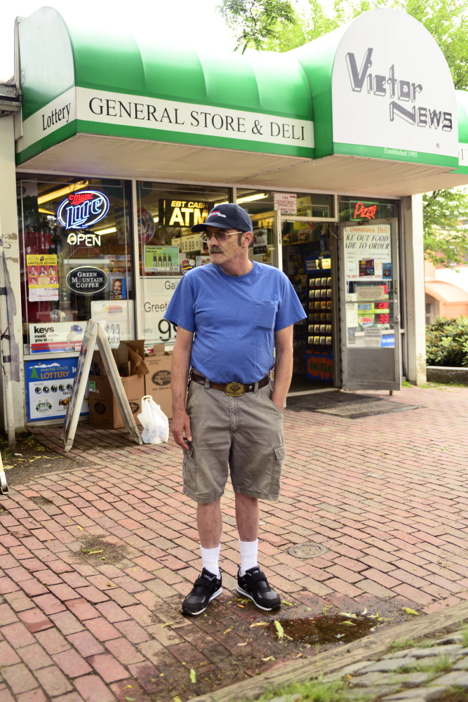 John Gulbert stands in front of the Victor News corner store on Park Street in downtown Lewiston on Thursday, June 26, 2014. Gulbert has lived in Lewiston for 54 years and believes the merger of Lewiston and Auburn would revive the downtown that has declined in the last 20 years.