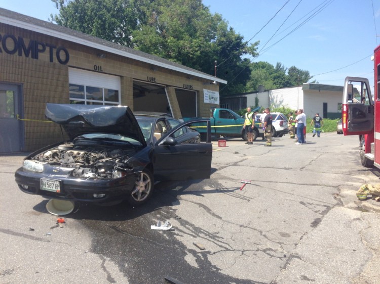 An Oldsmobile, foreground,  suddenly accellerated while waiting for service at a quick service oil change facility on Kennedy Memorial Drive in Waterville Tuesday. The force of the crash knocked a pick-up truck, seen in background, from its position in the service bay.