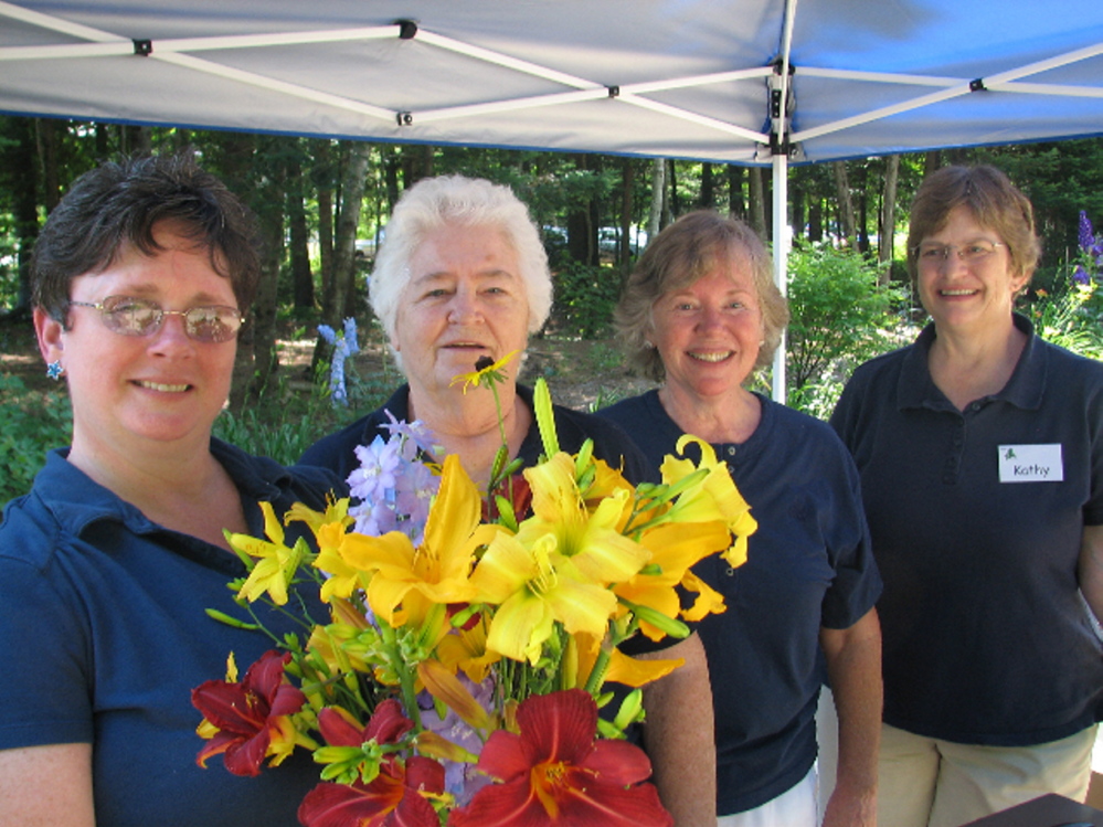 Maine-ly Harmony members Jan Flowers of Winterport, Gerry Dostie of Augusta, Sheryl Whitmore of Auburn and Kathy Greason of Hallowell welcome folks to last year’s  fundraiser.