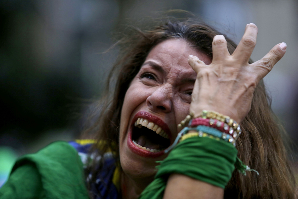 A Brazilian soccer fan cries as Germany scores against her team in Tuesday’s semifinal World Cup match.