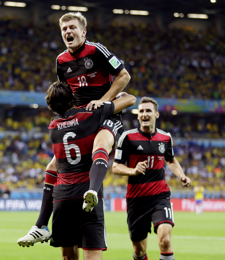 Germany’s Toni Kroos celebrates with Sami Khedira (6) and Miroslav Klose (11) after scoring his team’s fourth goal Tuesday.