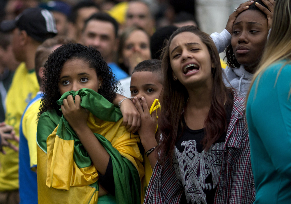 Brazilian soccer fans watch on TV in Sao Paulo as their team loses to Germany on Tuesday.