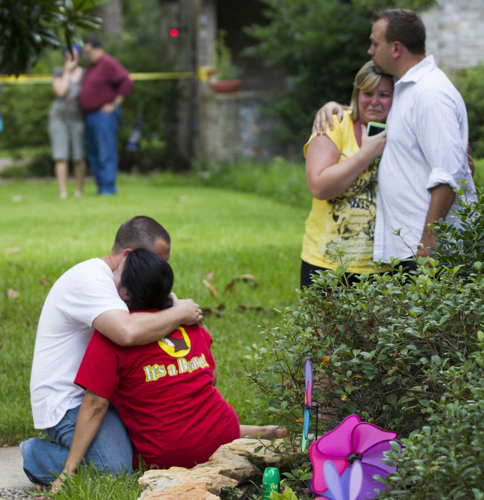 Neighbors embrace each other following a shooting Wednesday in Spring, Texas, a Houston suburb.
