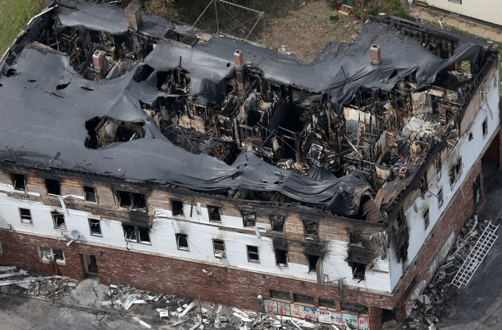 Fire engulfed the top floors of a three-story apartment and business building early Thursday in Lowell, Mass. Officials confirmed that seven people including three children died in the fire on Branch Street.