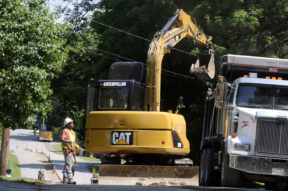 McGee Construction employees work Tuesday on Greenville Street in Hallowell as part of natural gas expansion into the city.