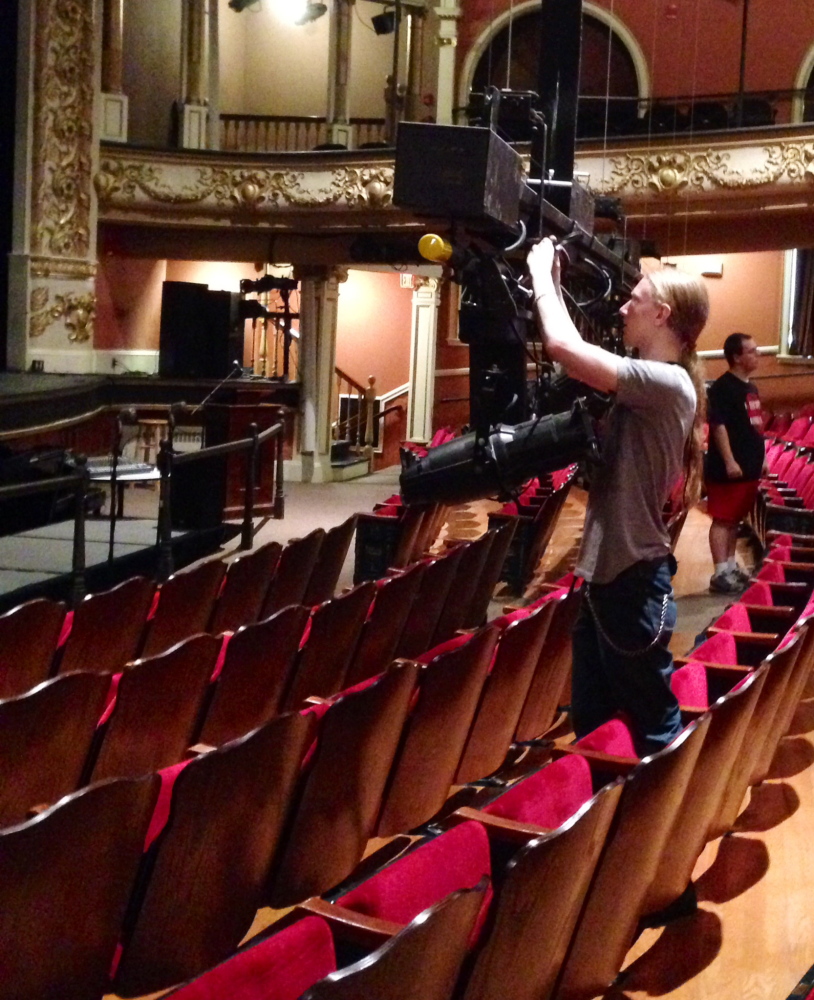 Isaac Woods, a tech assistant at the Opera House, completes final preparations for the Maine International Film Festival