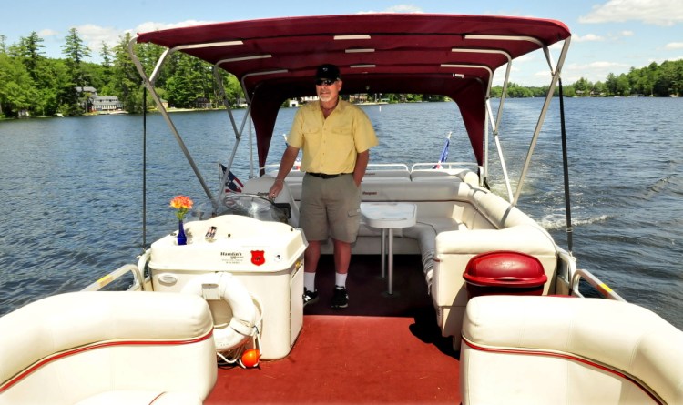 Gary Bennett, owner of Snow Pond Cruises, pilots his Snowdrifter ll boat on Thursday. The boat can carry up to 19 passengers for leisurely trips on Messalonskee Lake.