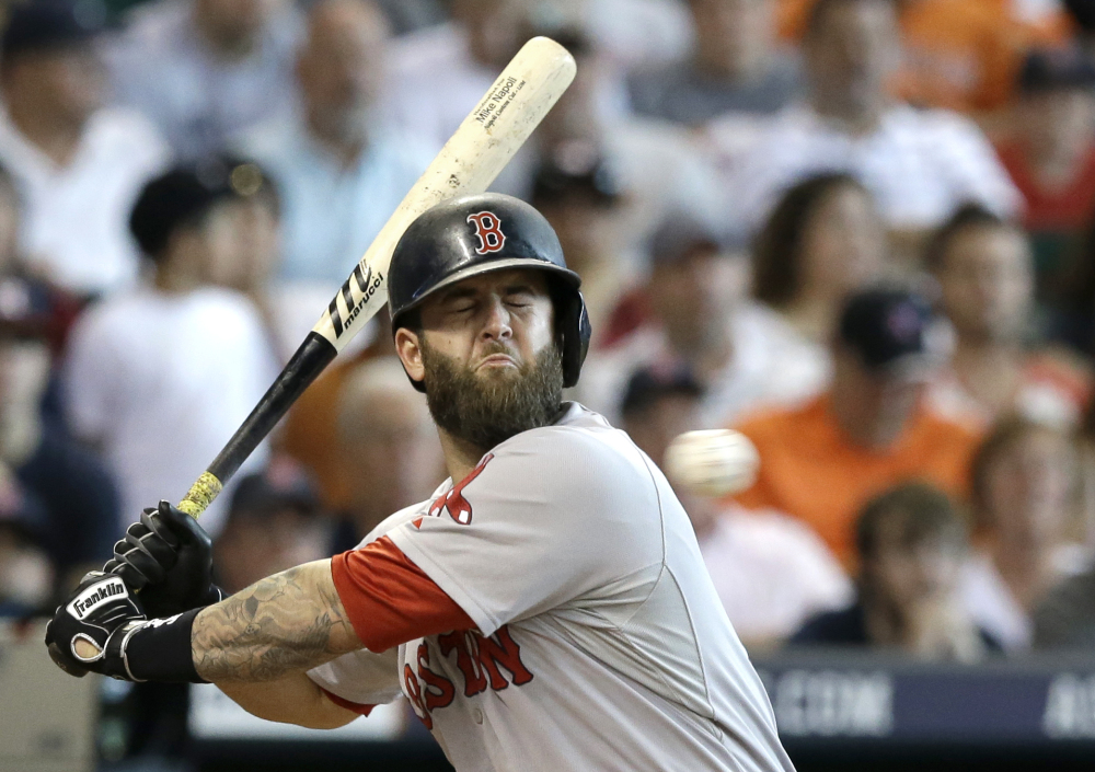 Boston’s Mike Napoli makes a face as he dodges an inside pitch during the seventh inning against the Houston Astros on Saturday in Houston.