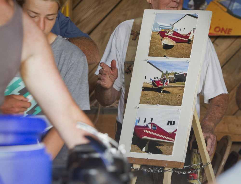 Photographs of Clarke Tate and the plane he was flying in during Saturday’s fatal crash are displayed Sunday at Sprague Field in Cape Elizabeth.