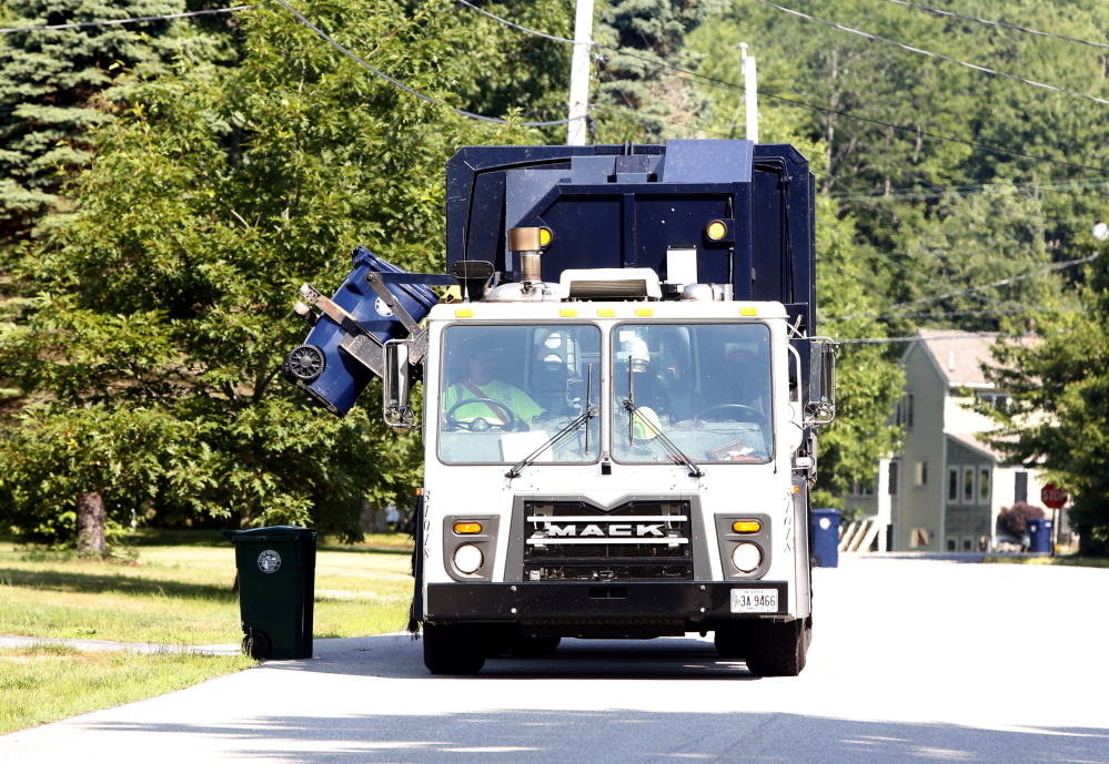 A Pine Tree Waste Services recycling truck empties a container Tuesday in Biddeford. The city of Biddeford has completed its first year of curbside recycling and saved more than $200,000 in trash disposal fees.