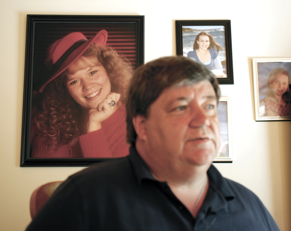 Stephen Reed recalls the death of his daughter Amanda, in a photograph behind him, during an interview Friday at his Bowdoinham home. Reed was a clerk in 2002 at the Motel 6 in Portland when he recognized two guests who were the target of a nationwide manhunt after the body of an infant was discovered in a plastic bin inside their abandoned pop-up camper. Reed, whose own daughter was dying at the time, was credited by police with saving the life of the young baby the couple was traveling with.