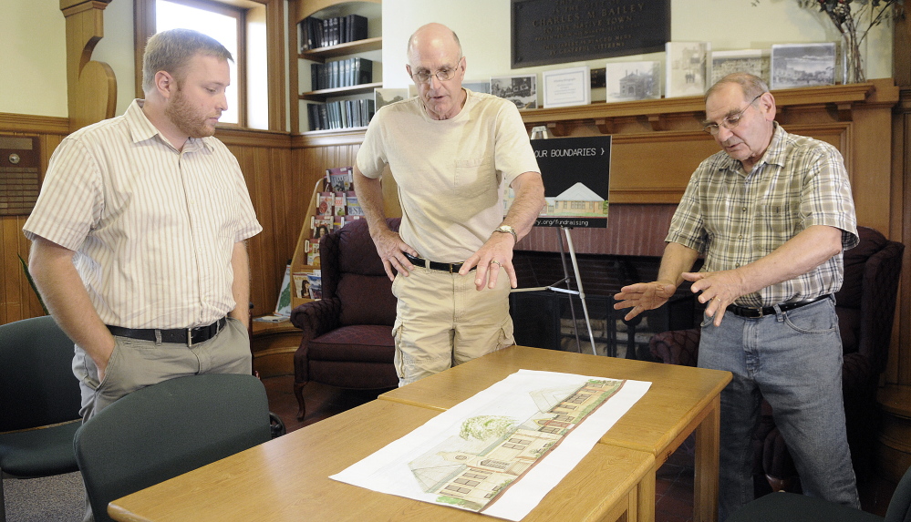 Charles M. Bailey Library architect Phil Locashio, right, steering committee member Dale Glidden, center, and librarian Richard Fortin discuss plans for the facility’s expansion while meeting at the library in Winthrop last week.