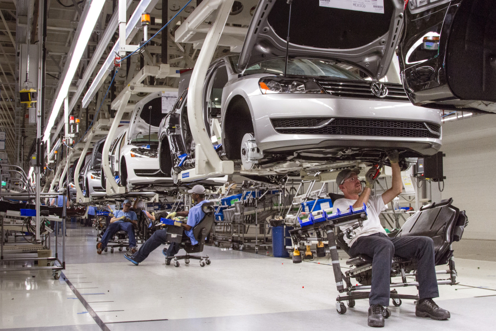 Employees at the Volkswagen plant in Chattanooga, Tenn., work on the assembly of a Passat sedan in this July 12, 2013 photo.