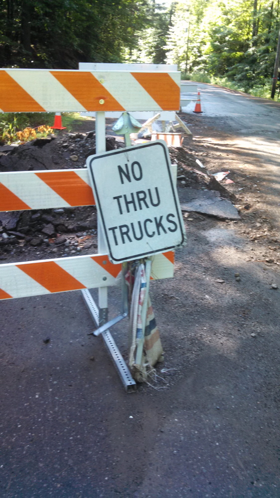 A sign warning trucks not to head down a closed dirt road have been vandalized in Phillips.