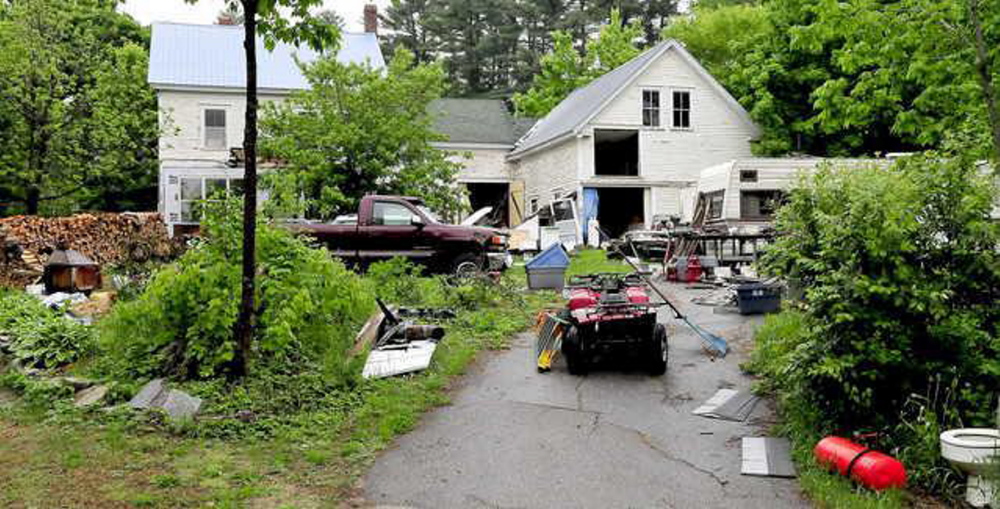 Photograph taken in June showing debris on the property of Duane Pollis in Wilton. Town officials say Pollis has made progress cleaning up the property and will be encouraged to continue his efforts.
