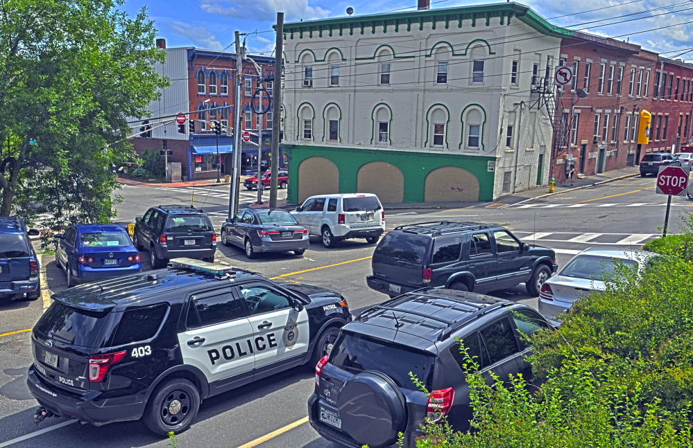 An Augusta police vehicle sits in traffic Thursday at the corner of Commercial and Bridge streets. Downtown business owners want city council to approve more funding to pay for extra patrols in the downtown because of problems with illegal and intimidating behavior by vagrants.