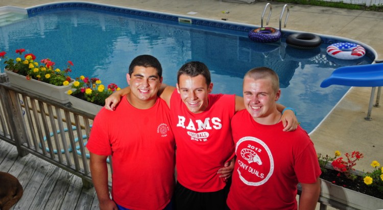Kyle Armstrong, center, was rescued by friends Elias Younes, left, and Devon O’Connor when he had a seizure in this pool at O’Connor’s Augusta home.
