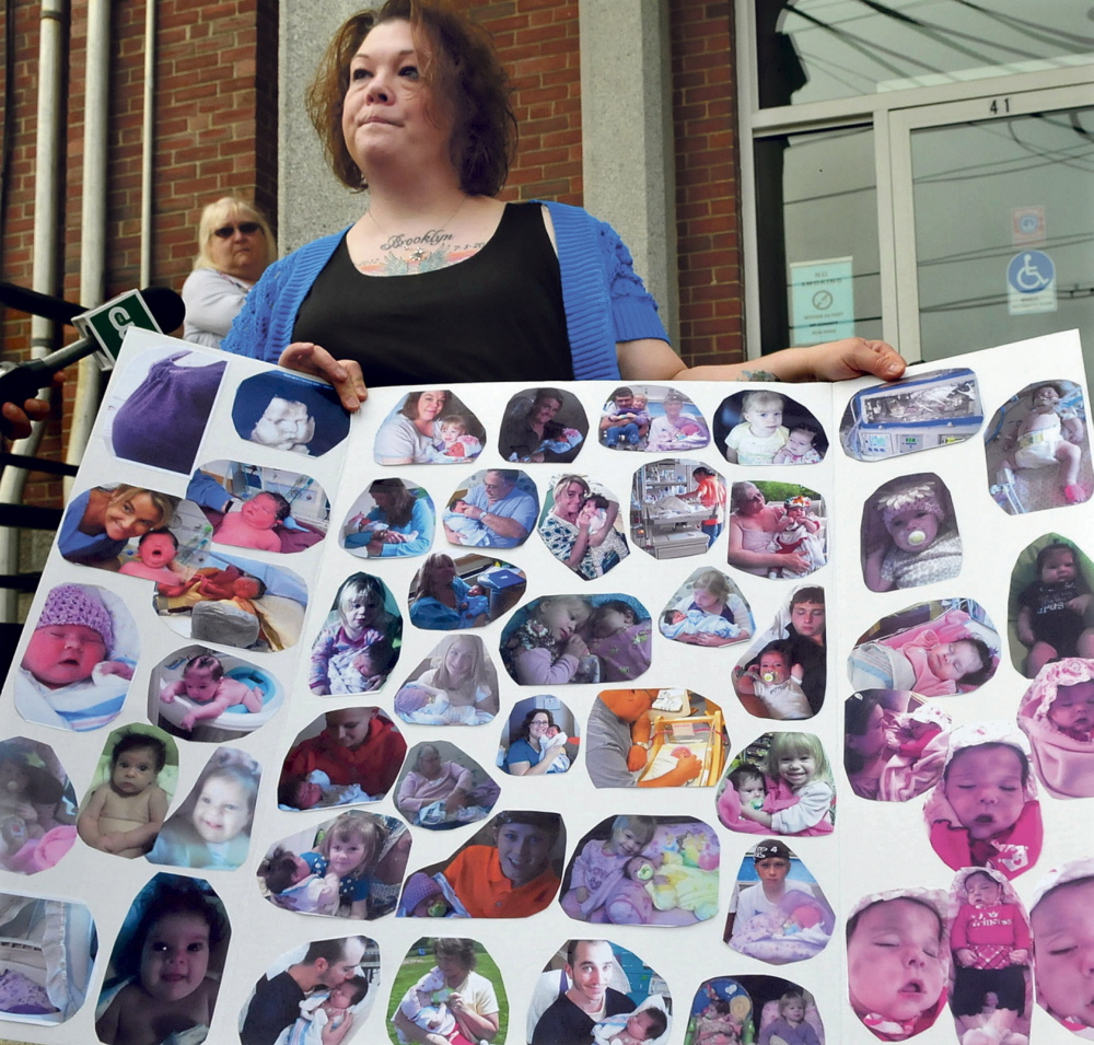 Nicole Greenaway displays pictures of her daughter Brooklyn Foss-Greenaway on the steps of the Somerset Superior Court in Skowhegan in May.