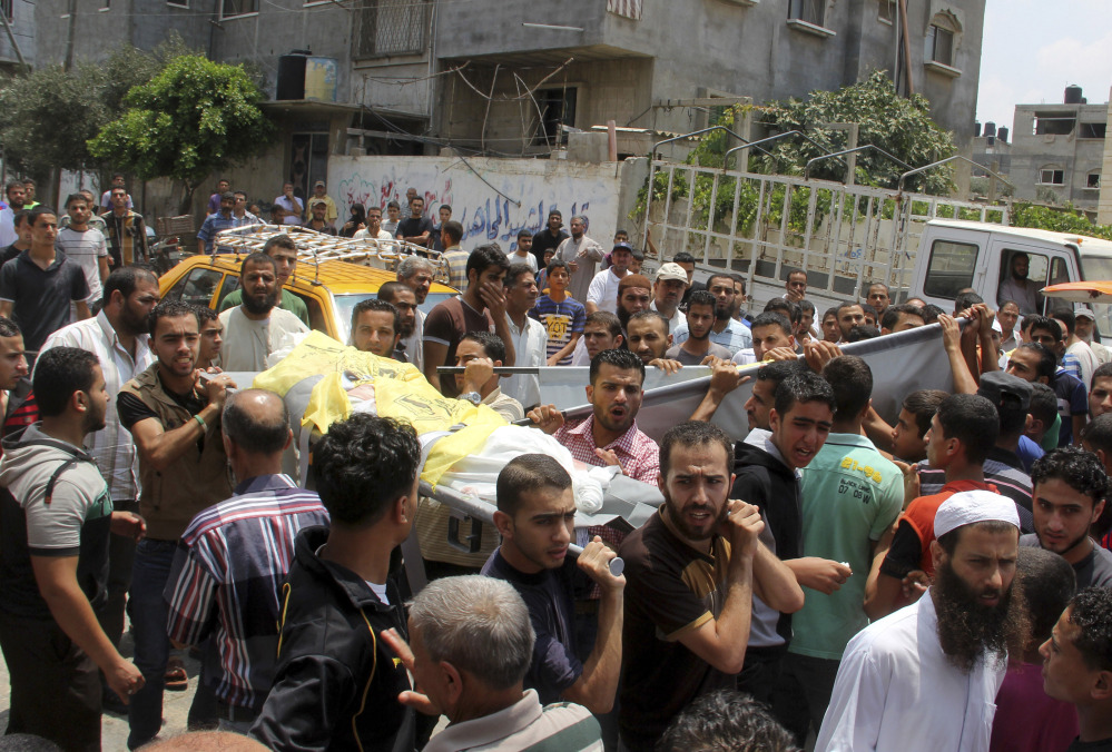 The Associated Press Palestinians carry the bodies of the brothers Hamza and Anas Abu Moamar, who were killed along with their brother, Mohammed Abu Moamar, at their family house in an airstrike, during their funeral in Rafah, in the southern Gaza Strip, on Sunday. The three brothers were killed early Sunday in Rafah by an airstrike, according to Gaza health ministry official Ashraf al-Kidra.