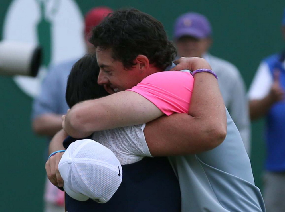 Rory McIlroy celebrates winning the British Open Golf championship with his mother, Rosie, after the final round at the Royal Liverpool golf club in Hoylake, England, on Sunday.
