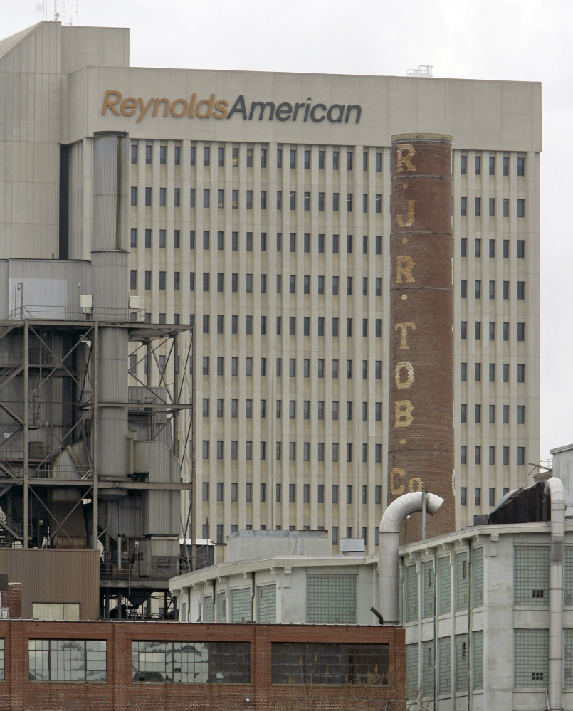 In this Feb. 6, 2008 photo, a smokestack of an old R.J. Reynolds Tobacco plant frames the Reynolds American building in Winston-Salem, N.C., A Florida jury has slammed R.J. Reynolds Tobacco Co. with $23.6 billion in punitive damages in a lawsuit filed by Cynthia Robinson, the widow of a longtime smoker who died of lung cancer in 1996.