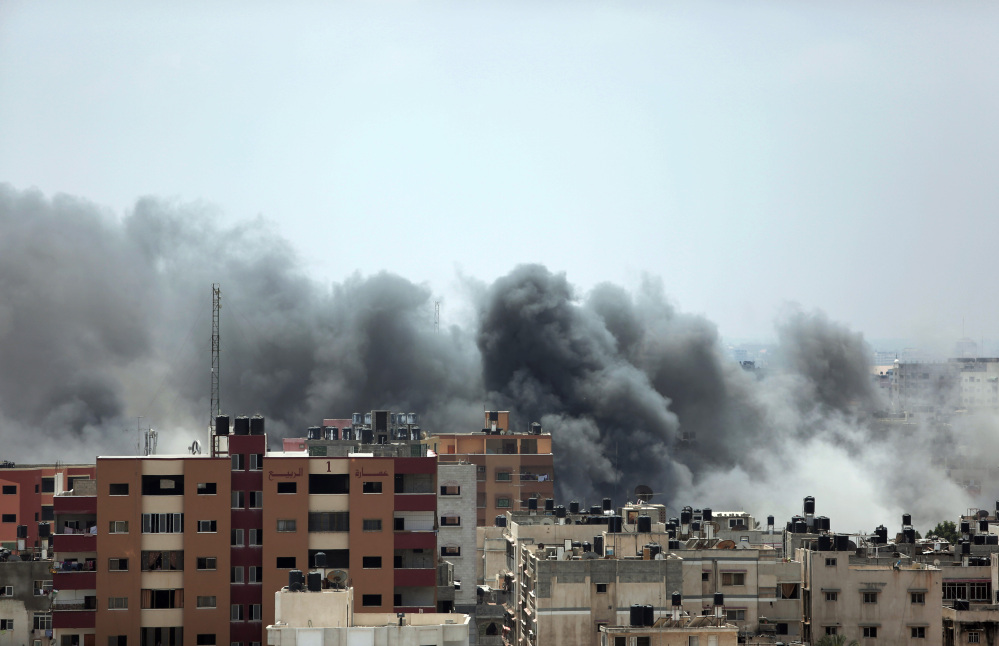 Smoke rises after an Israeli missile strike hit Gaza City on Monday. On Sunday, the first major ground battle in two weeks of Israel-Hamas fighting exacted a steep price, killing scores of Palestinians and over a dozen Israeli soldiers and forcing thousands of terrified Palestinian civilians to flee their devastated Shijaiyah neighborhood, which Israel says is a major source for rocket fire against its civilians.