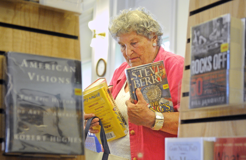 Randolph resident Shirley Hanley selects books Monday at the Gardiner Public Library. Randolph residents will decide at Town Meeting on Wednesday whether the town should end its relationship with the Gardiner Public Library.