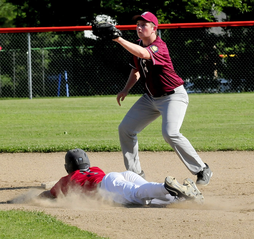 Post 51 runner Zach Mathieu slides safely into second base as Franklin County Flyers’ Sebastian Lombardi waits for throw Monday in Skowhegan. Post 51 won 10-0.