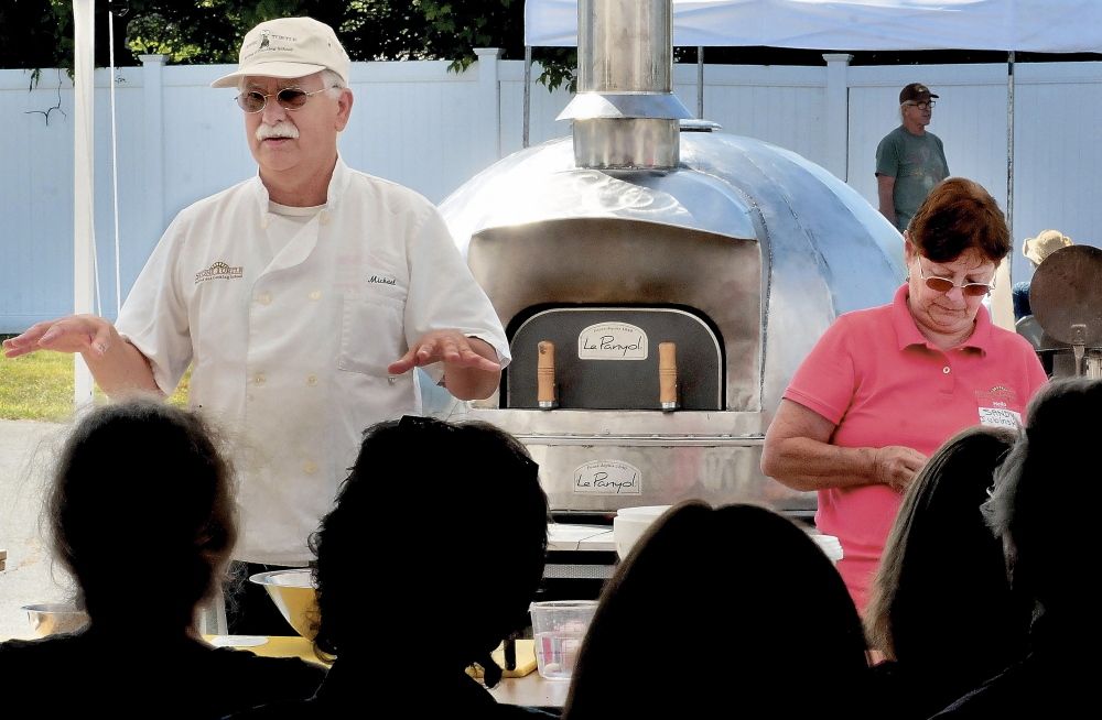 Michael Jubinsky explains the process of making bread in a wood-fired oven during a workshop that was part of last year’s Kneading Conference and Artisal Bread Fair in Skowhegan. This year’s three-day conference begins Thursday.