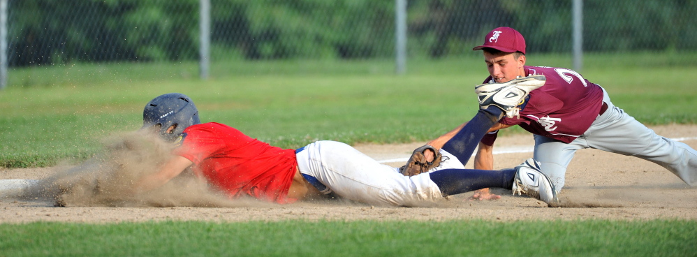 Post 51’s Jake Dexter, 7, is tagged out after trying to steal 3rd base in the American Legion Zone 2 championship game at Memorial Field in Skowhegan on Tuesday.