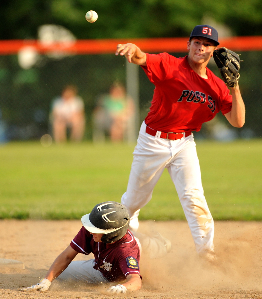 Post 51’s A.J. Godin turns the double play as Franklin County’s Scott Hall tries to break it up Tuesday in the American Legion Zone 2 championship at Memorial Field in Skowhegan.