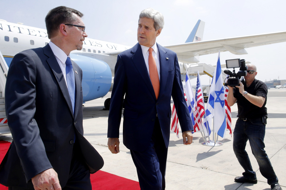 U.S. Secretary of State John Kerry walks with U.S. Embassy Deputy Chief of Mission Bill Grant as he arrives to Tel Aviv Wednesday, July 23, 2014. Kerry is meeting with U.N. Secretary-General Ban Ki-moon, Israeli Prime Minister Benjamin Netanyahu, and Palestinian Authority President Mahmoud Abbas as efforts for a cease-fire between Hamas and Israel continue.