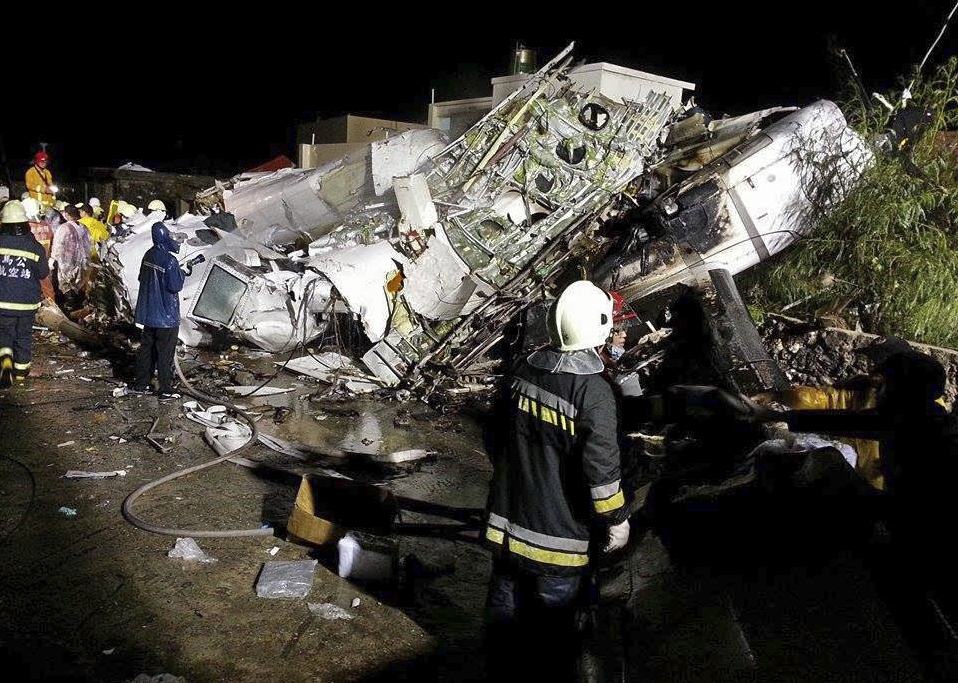 Rescue workers survey the wreckage of TransAsia Airways flight GE222 which crashed while attempting to land in stormy weather on the Taiwanese island of Penghu, late Wednesday.