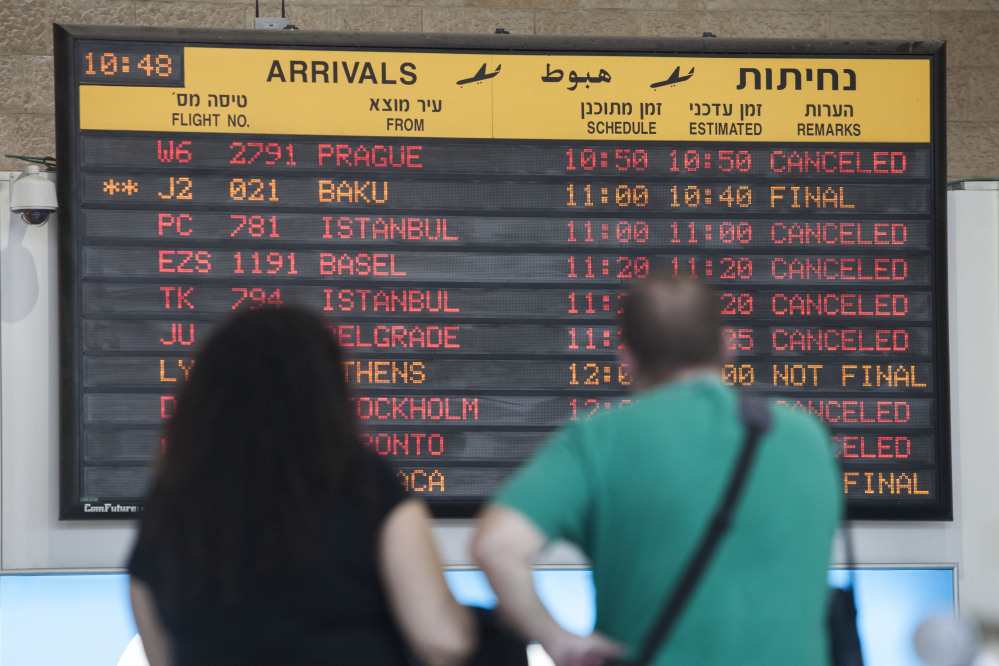 A arrivals flight board displays various canceled and delayed flights in Ben Gurion International airport a day after the U.S. Federal Aviation Administration imposed a 24-hour restriction on flights after a Hamas rocket landed Tuesday within a mile of the airport, in Tel Aviv, Israel.