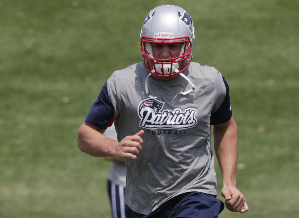 In this June 17, 2014, file photo, New England Patriots tight end Rob Gronkowski  runs during an NFL football minicamp in Foxborough, Mass.