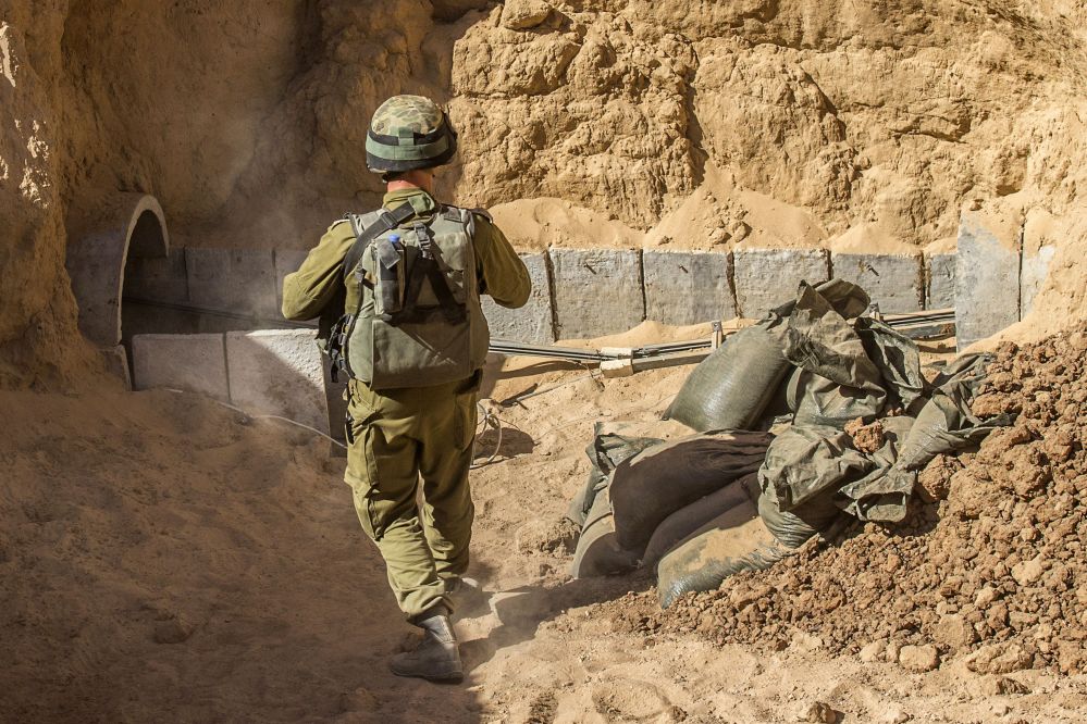 An Israeli army officer on Friday walks near the entrance of a tunnel that is allegedly used by Palestinian militants for cross-border attacks, at the Israel-Gaza border. The tunnel network is taking center stage in the latest war between Hamas and Israel.