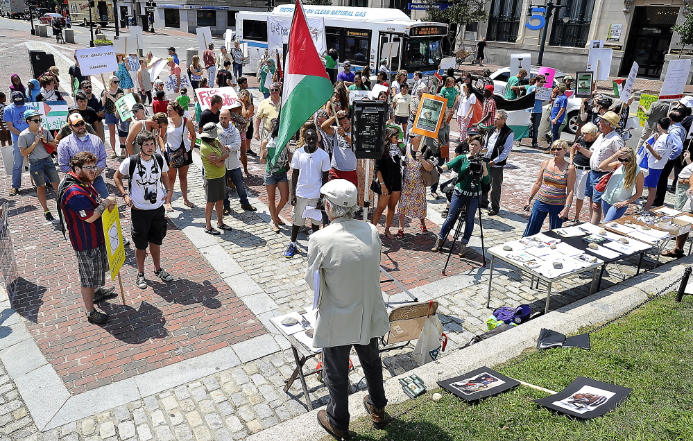 PORTLAND, ME - JULY 24: Bob Schaible of Buxton. chair of Maine Voices for Palestinian Rights, urges the signing of petitions by the Pro-Palestinian protesters who condemn Israel's bombing of Gaza in response to Hamas'  bombing of Israel in a protest in Monument Square. (Photo by Gordon Chibroski/Staff Photographer)