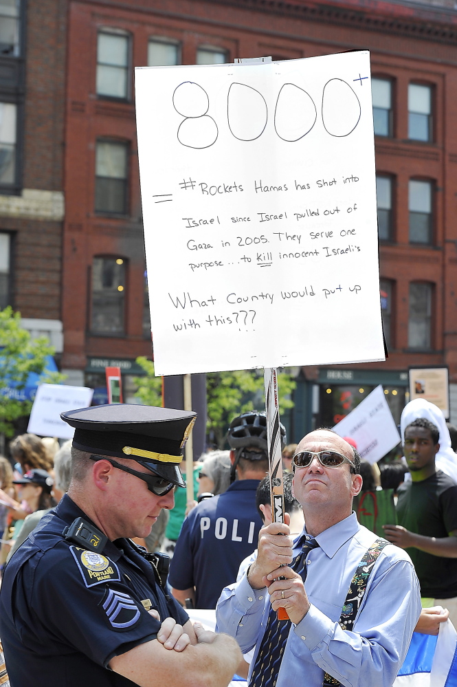 PORTLAND, ME - JULY 24: Mickey Haas of Portland was the only Israel supporter in the group as Pro-Palestinian protesters condemn Israel's response to the bombing of Israel by Hamas in a protest in Monument Square. (Photo by Gordon Chibroski/Staff Photographer)
