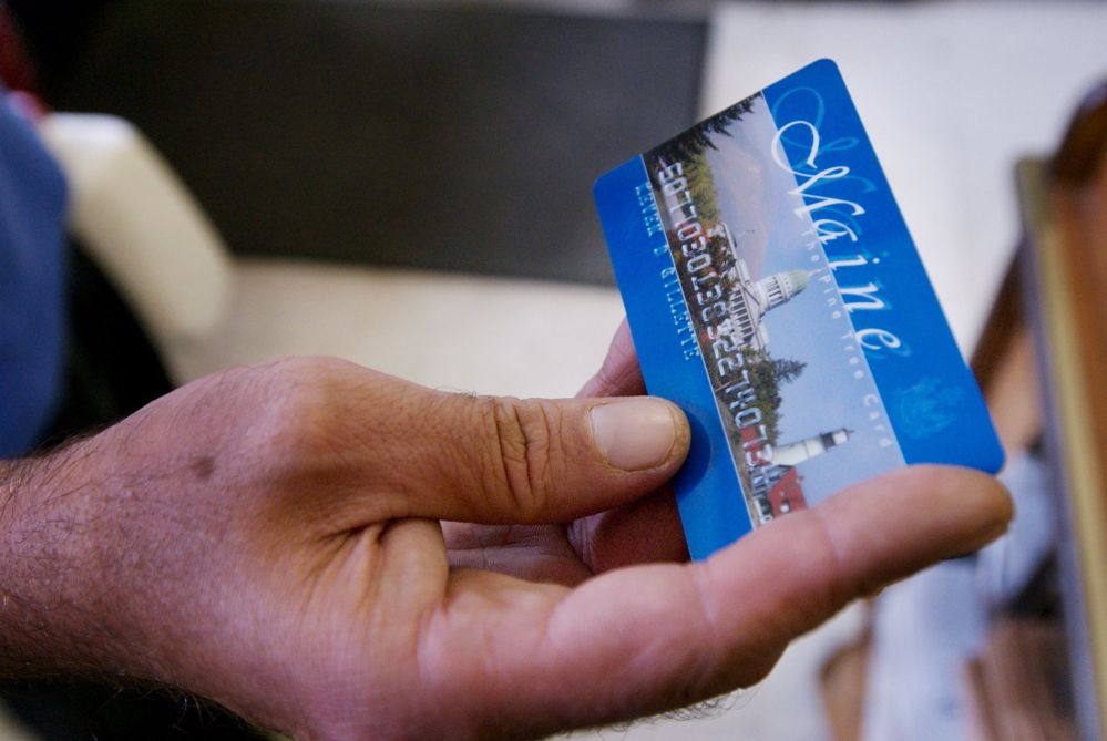 A Portland man uses a magnetic food stamp card to pay for his groceries in 2008. Gov. Paul LePage announced this week that he intends to reinstate work requirements for some Maine adults who are applying for Supplemental Nutrition Assistance Program benefits.