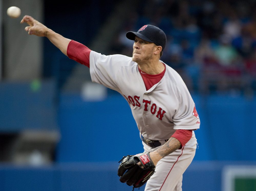 Boston Red Sox starting pitcher Jake Peavy works against the Toronto Blue Jays during the first inning of a baseball game, Tuesday in Toronto.