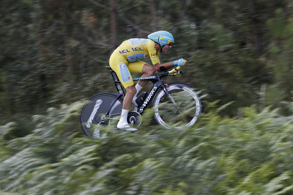 Italy’s Vincenzo Nibali, wearing the overall leader’s yellow jersey, strains during the twentieth stage of the Tour de France cycling race, an individual time-trial over 54 kilometers (33.6 miles) with start in Bergerac and finish in Perigueux, France, Saturday.