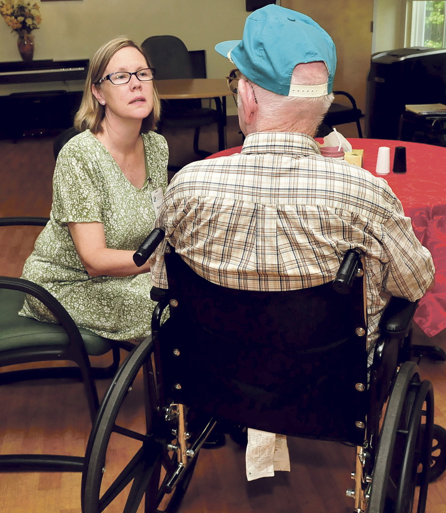 Mary Ford, owner of Pittsfield Rehab and Nursing, speaks with a resident on Wednesday. The nursing home will close by September.