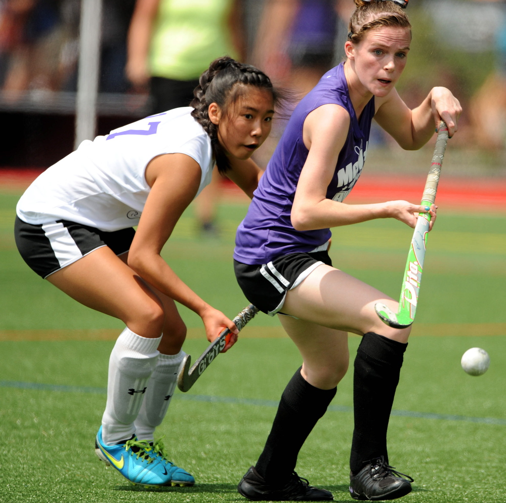 West senior All-Star Junyoung Shin, left, and East senior All-Star Braley Leadbetter battle for the ball in the McNally Senior All-Star Field Hockey Game on Saturday at Thomas College in Waterville. The East won 2-0.