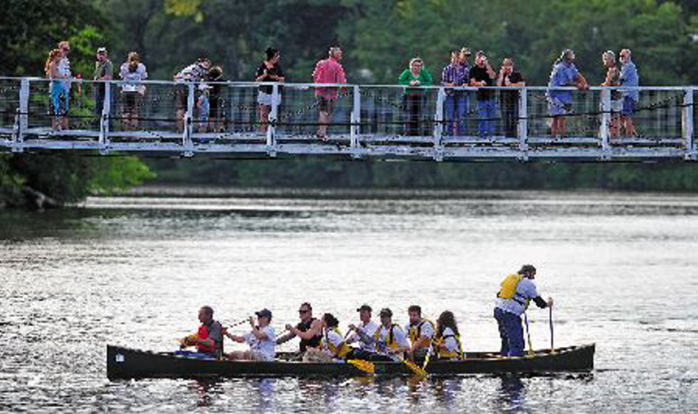 The winning New Balance team crosses the finish line at the suspension bridge in the 2013 Skowhegan River Fest boat races on the Kennebec River. The races will once again be part of Skowhegan’s annual River Fest.